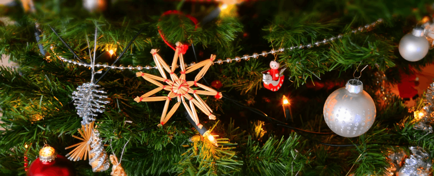 A decorated Christmas tree featuring ornaments, garlands, and a star.