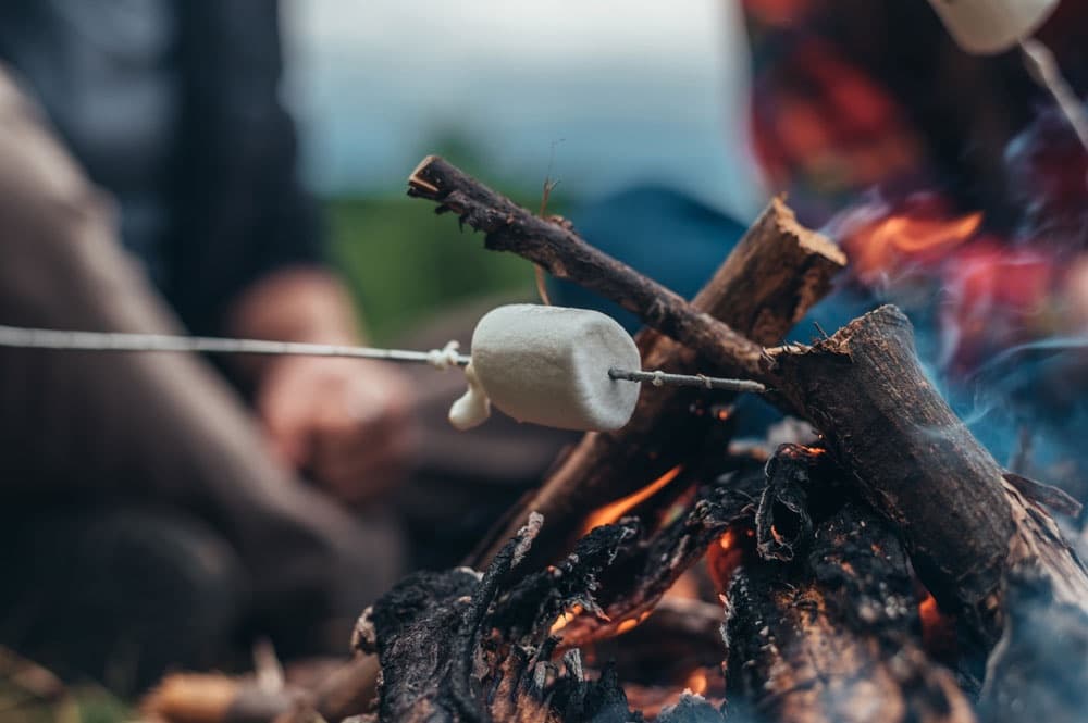 A marshmallow toasting over a campfire.