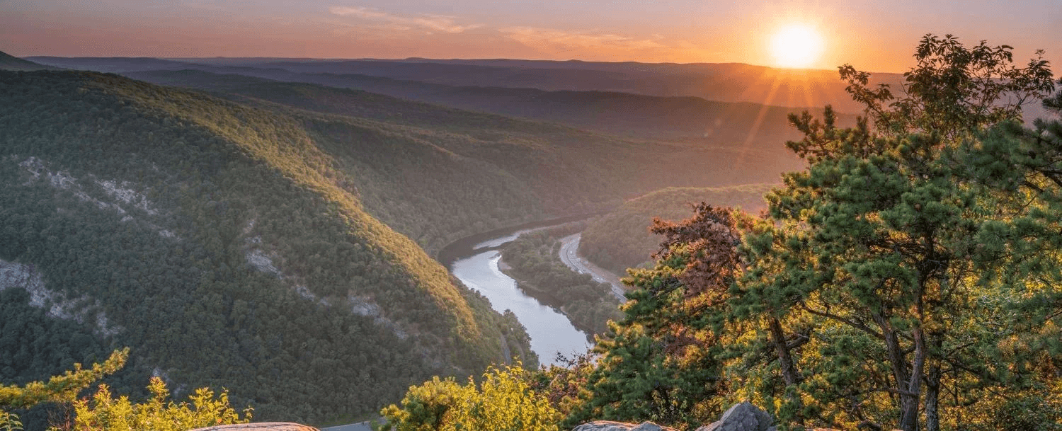 Sunset view over rolling hills and a winding river. Sunset view over rolling hills and a winding river.
