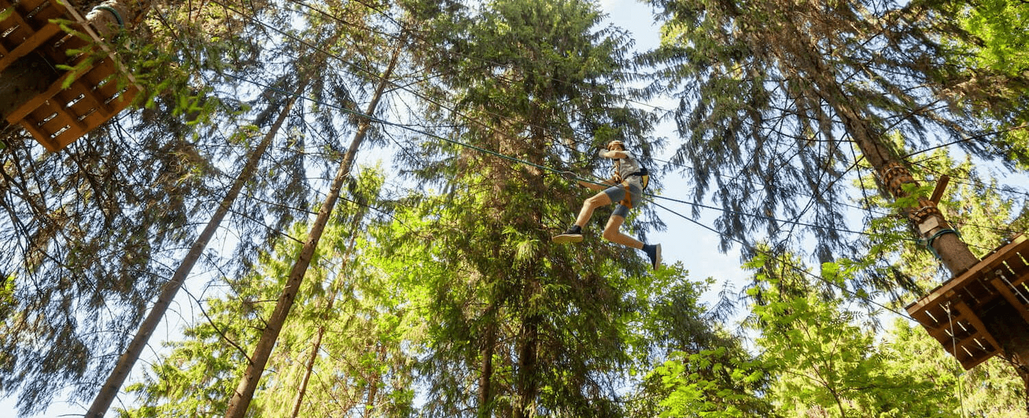 Young man zip lining.