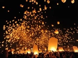 Hundreds of lanterns amidst a black sky during a lantern festival